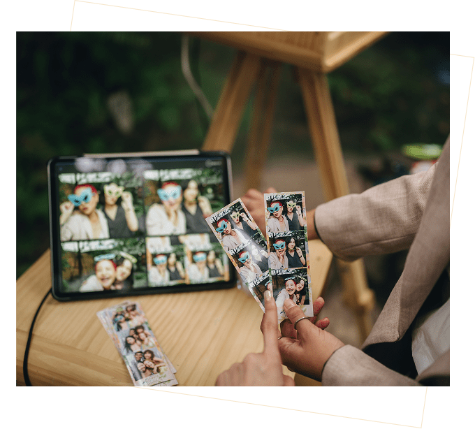 Hands holding photo strip prints